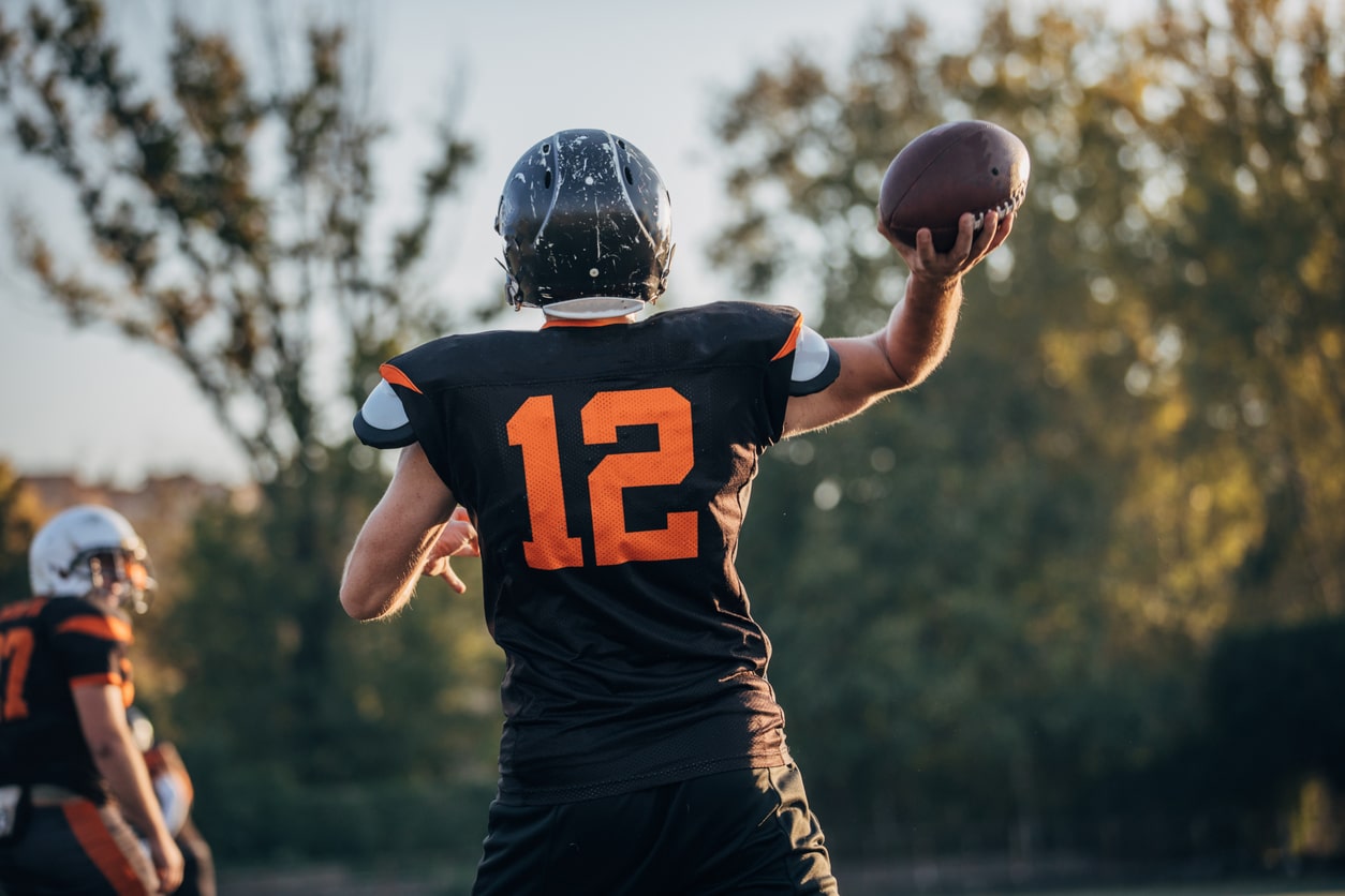 Man throwing a football after treatment for sports injuries at Union County Orthopaedic Group