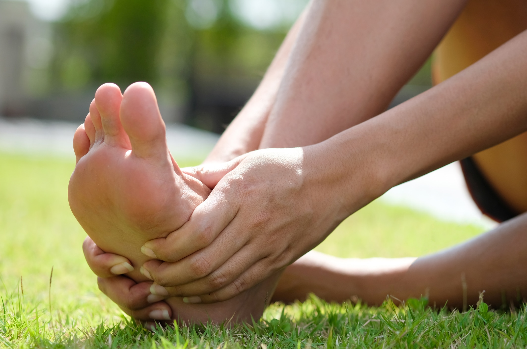 Woman with a hammertoe looking at her feet
