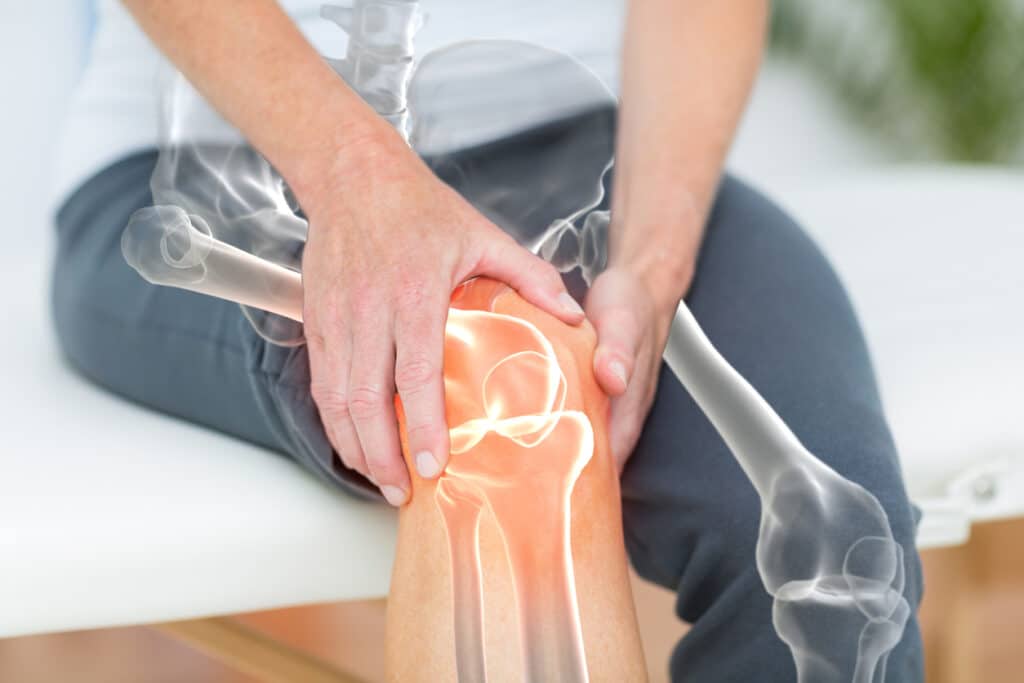 Cropped shot of man holding knee after knee replacement in Union County, NJ